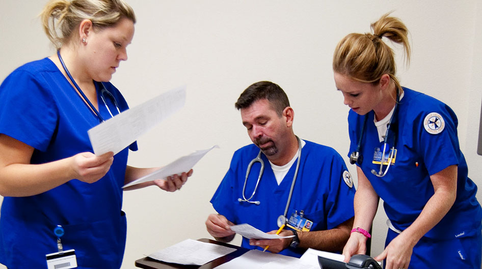 Three nursing students comparing notes