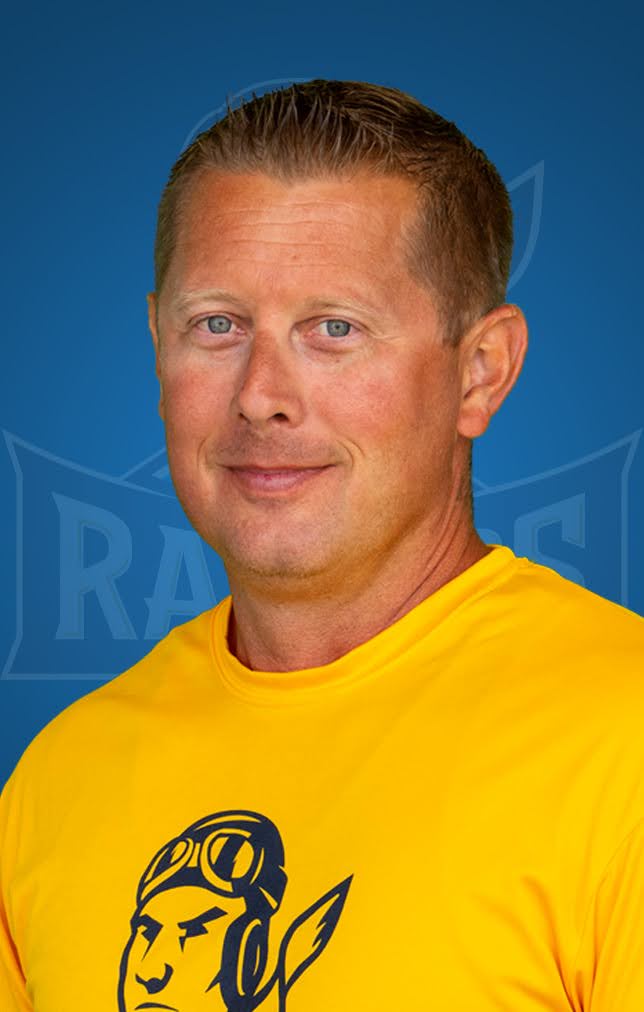 Professional headshot of a smiling man wearing a Rose State College Athletics polo shirt.