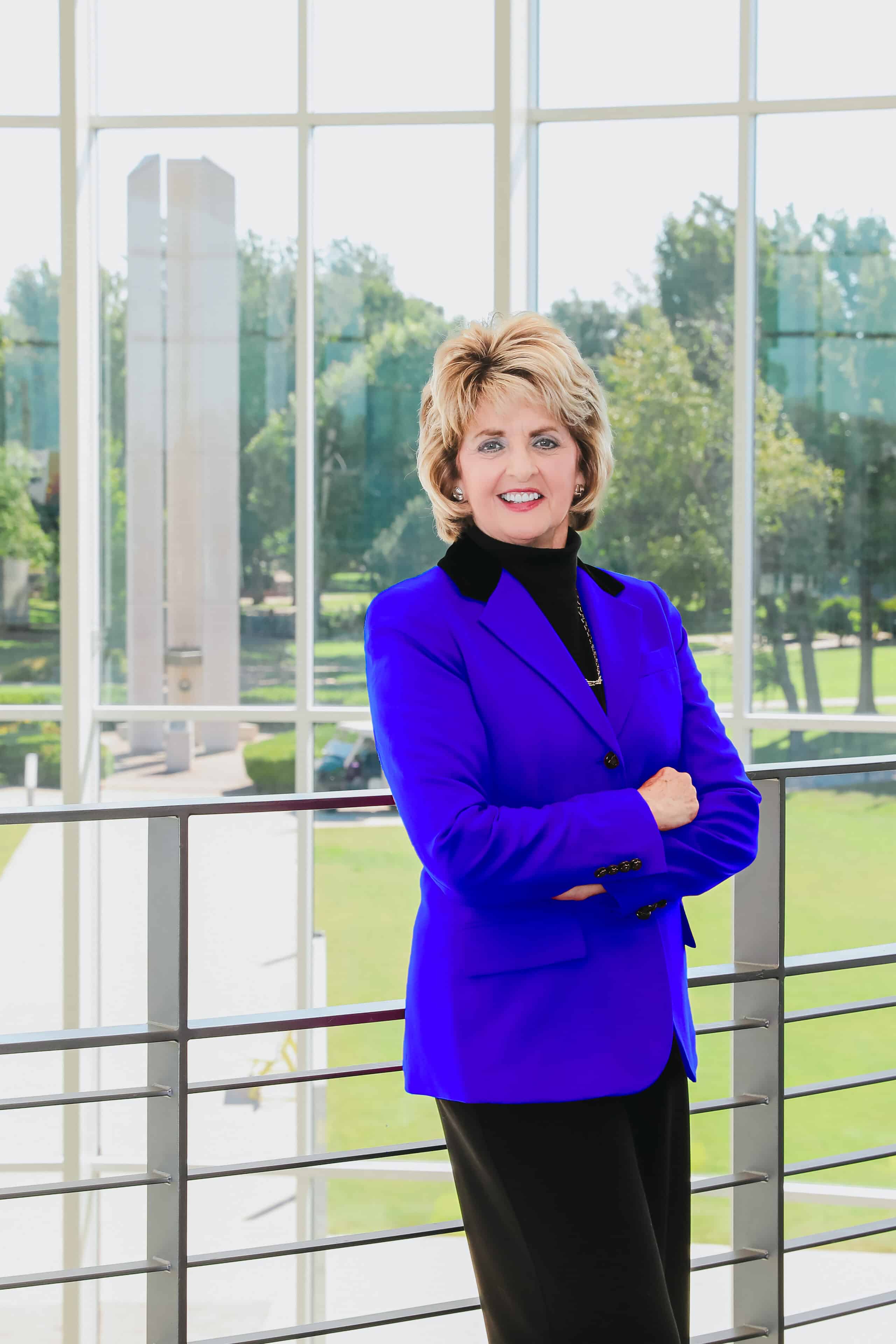 Dr. Jeanie Webb poses with arms crossed in the student union