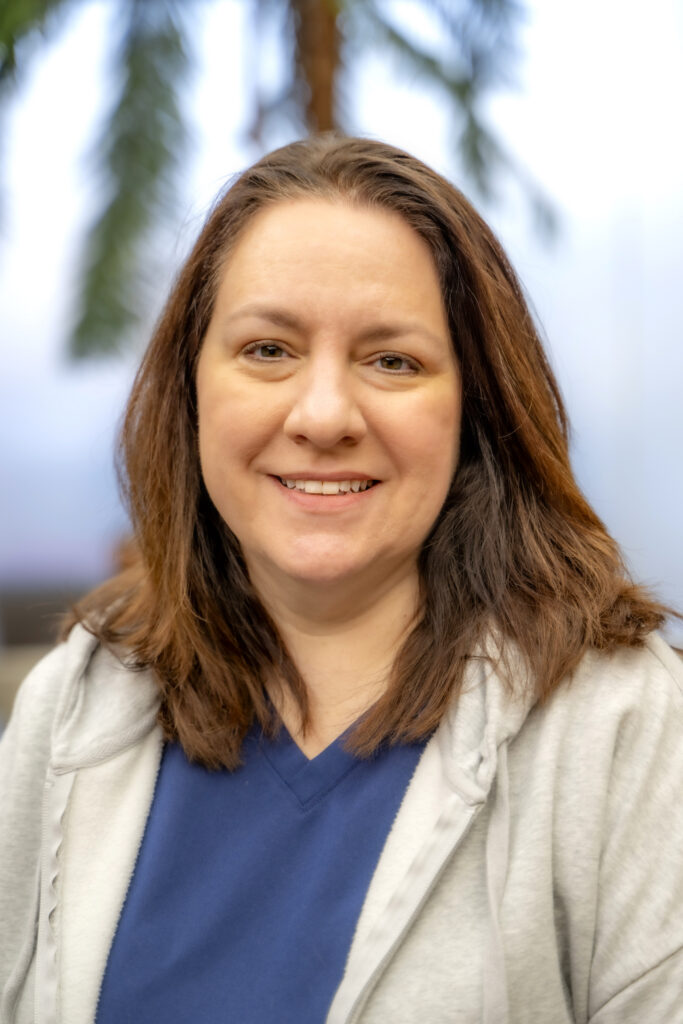 Portrait of a Rose State College staff member wearing a blue top and light jacket, smiling at the camera.