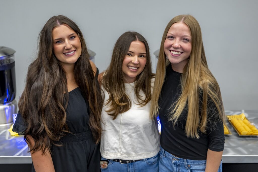 Three Rose State College radiologic technology students smile together during a pinning ceremony reception.